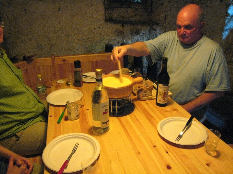 Table in a carnotzet with fondue on an alcohol lamp